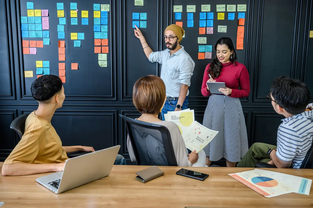 Colleagues discussing ideas and sticky notes during a meeting